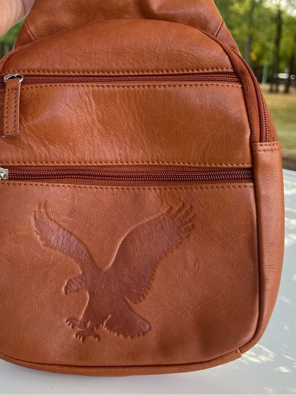 Leather Sling Bag in Cognac Brown with Eagle Emboss
